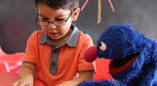 Boy playing with Grover